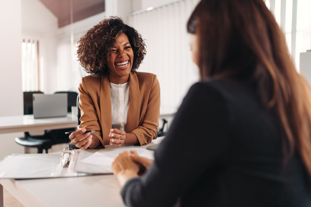 Happy African-American woman helping customer